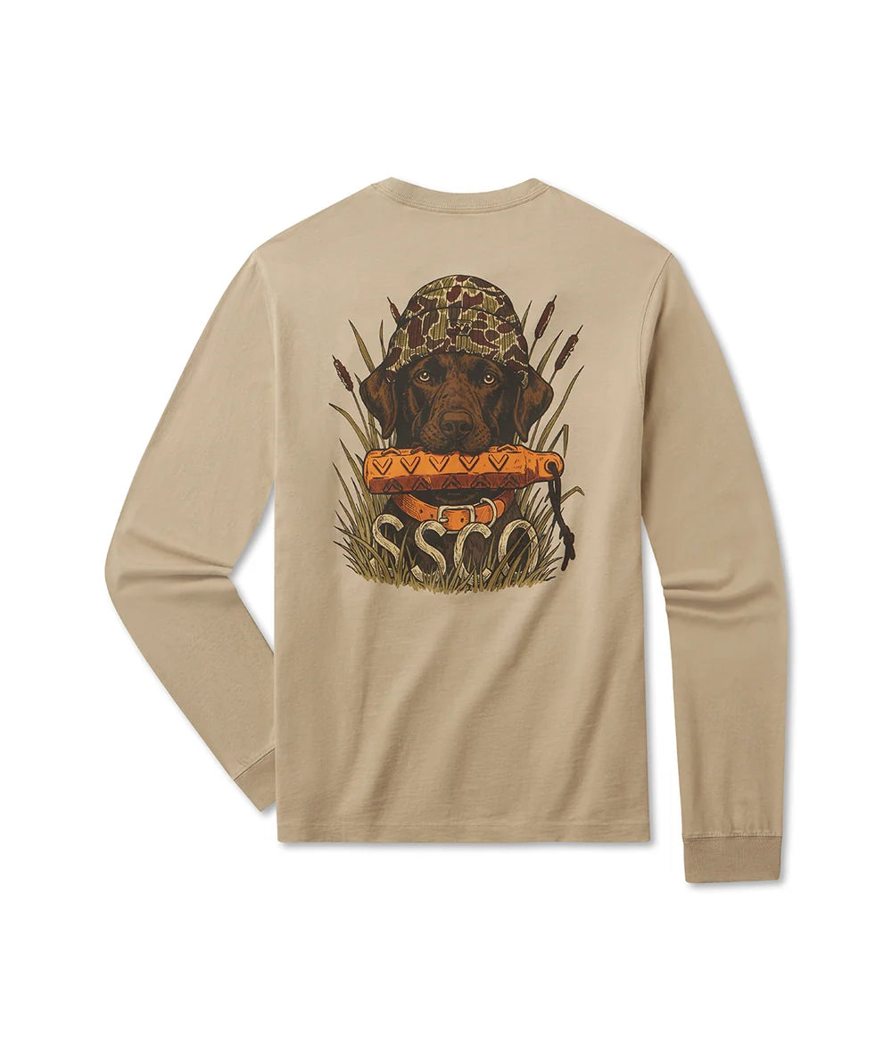 A beige long-sleeve t-shirt shown from the back, featuring a large graphic print of a brown dog wearing a camouflage hunting hat and holding an orange duck hunting quiver, with the text 'SSC' and 'HUNTER' printed below.