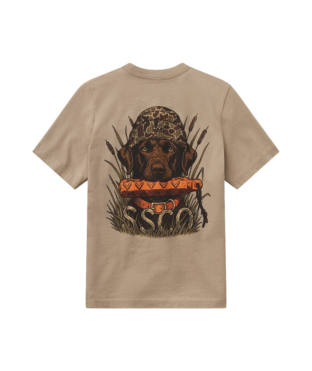 A beige short-sleeve t-shirt shown from the back, featuring a large graphic print of a brown dog wearing a camouflage hunting hat and holding a bright orange rodent, with the word 'ESCO' written below.
