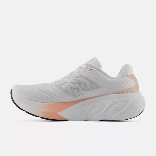 White running shoe with pink accent on a white background