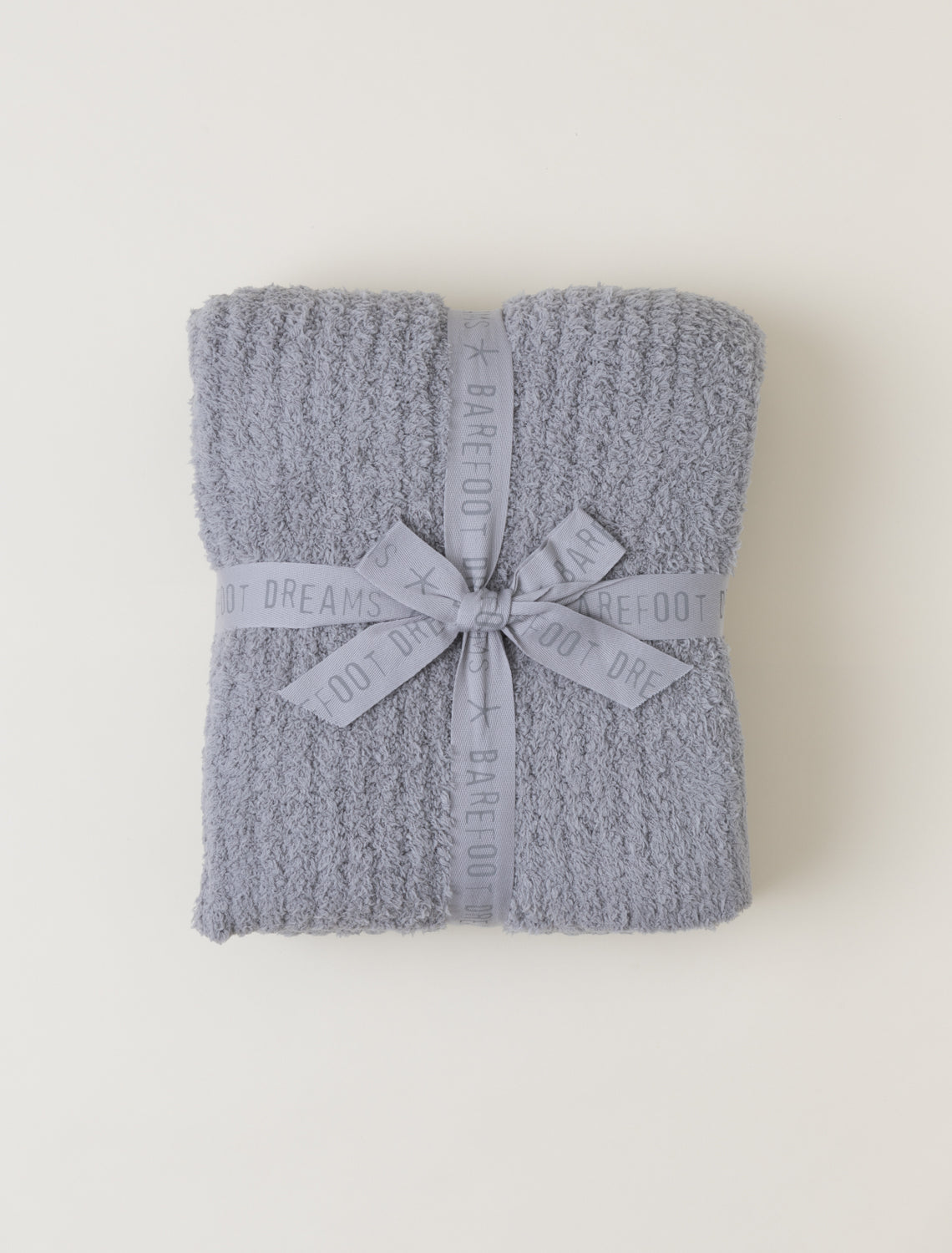 Folded gray blanket with a ribbon on a white background