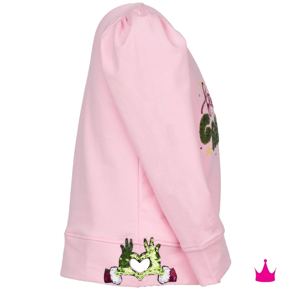 A pink hooded sweatshirt shown from the side, featuring green sequined hands holding a white heart on the cuff and a matching green sequined graphic on the upper sleeve.
