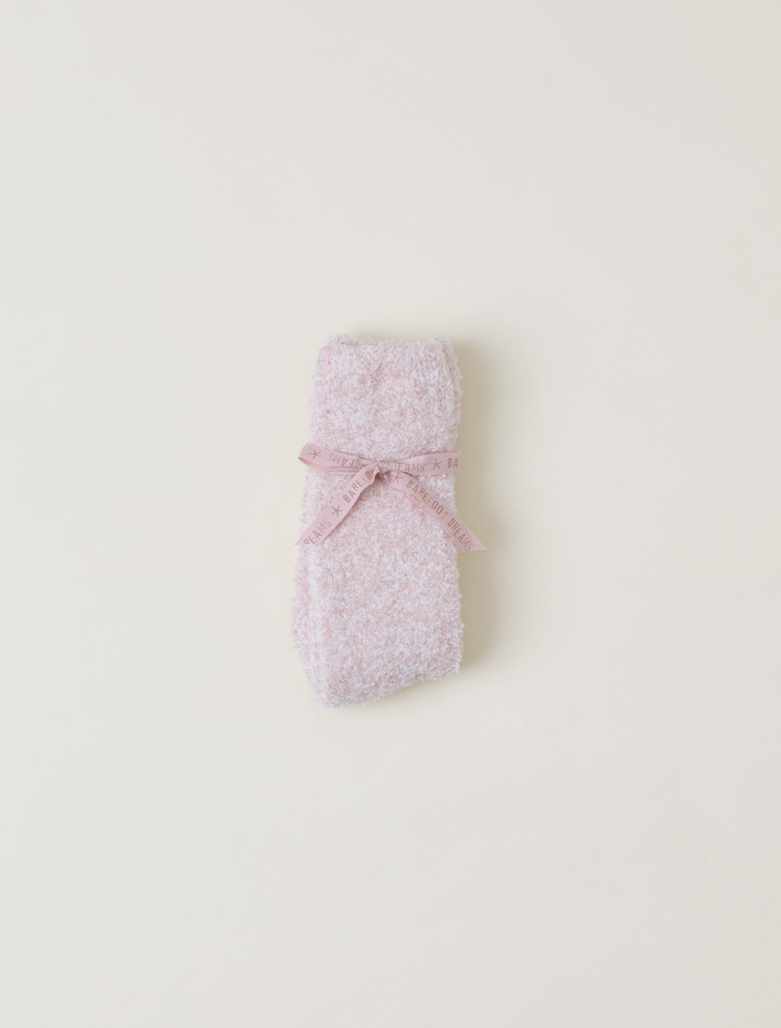 Pink textured socks on a light beige background