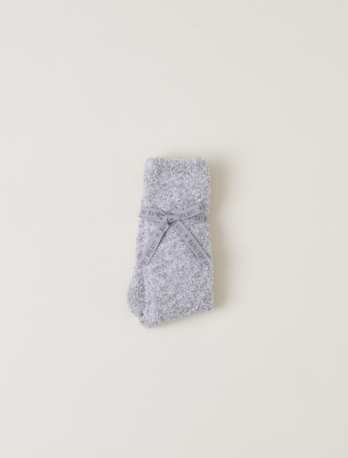 Gray knitted socks on a light beige background