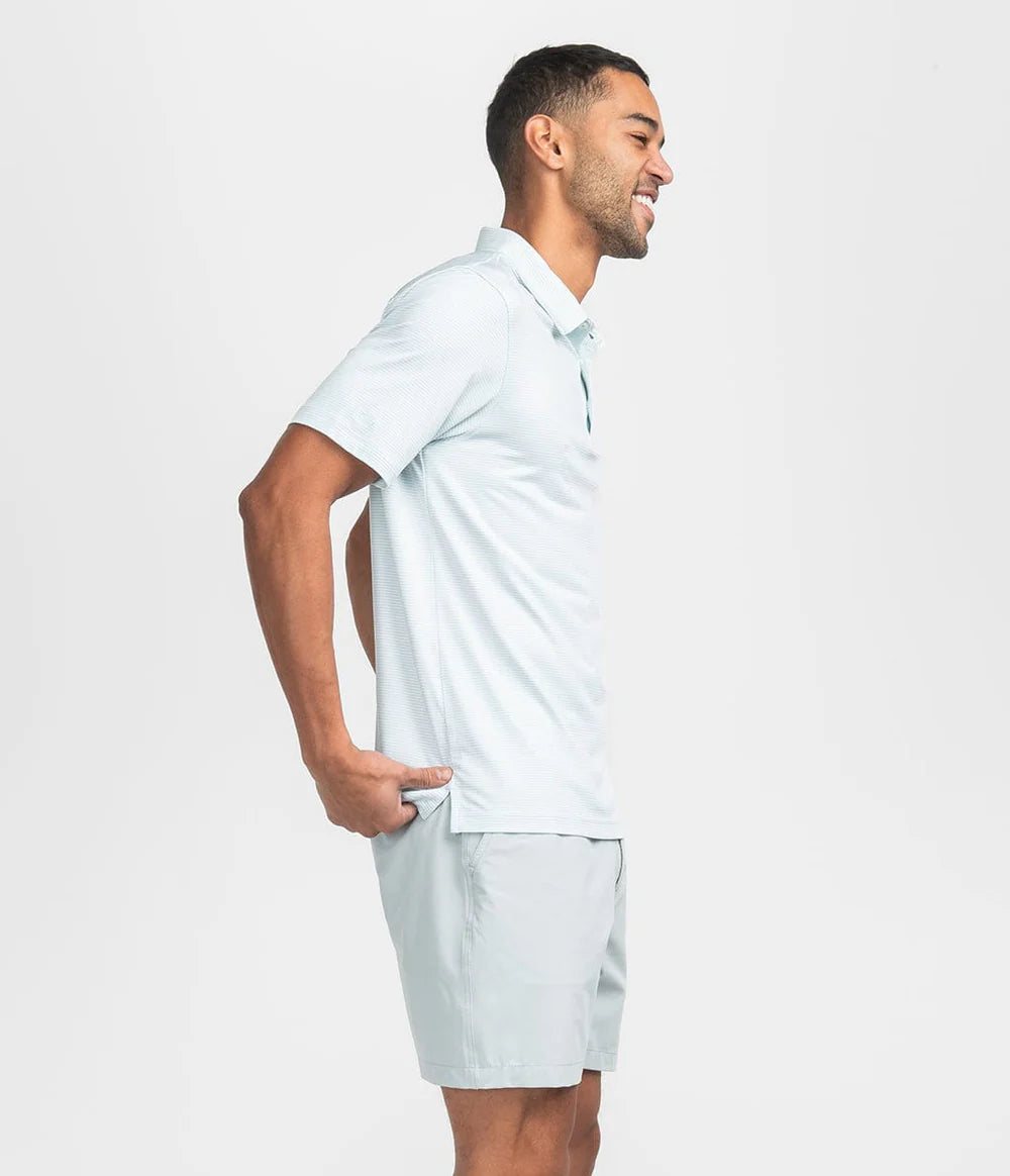 man wearing a green and white striped polo