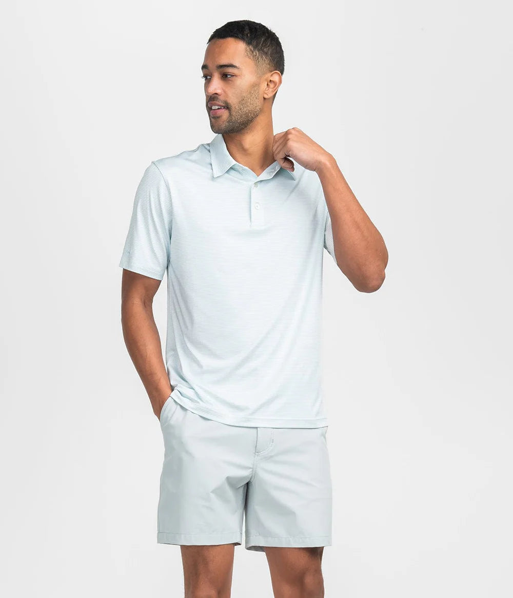 man wearing a green and white striped polo