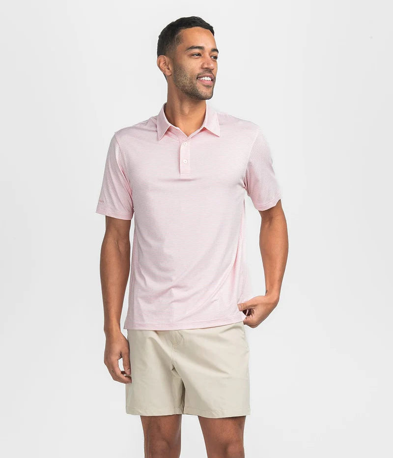 man wearing a peach and white striped polo