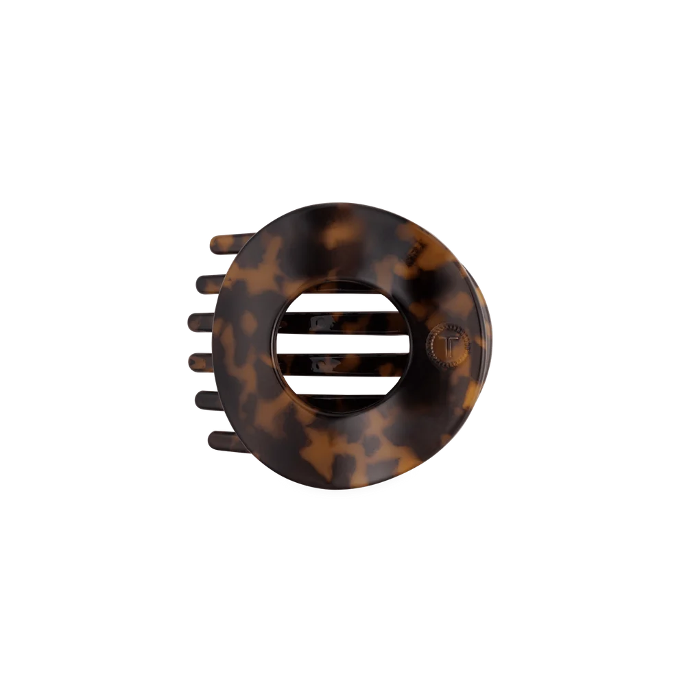 A tortoiseshell hair claw clip shown from a top-down view on a solid white background.
