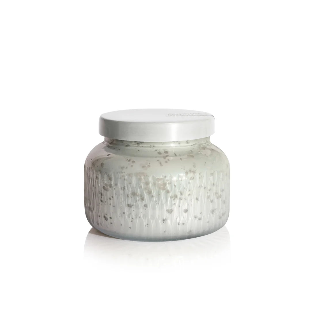 Silver jar with textured surface on a white background
