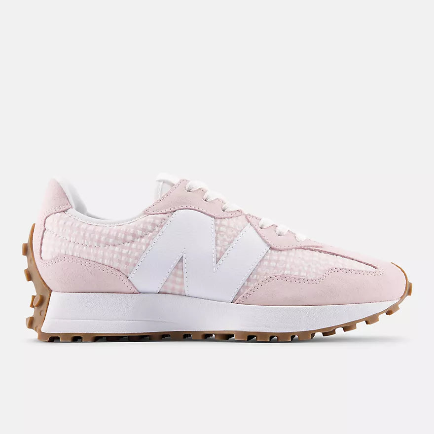 Pink sneaker with white accents on a light gray background