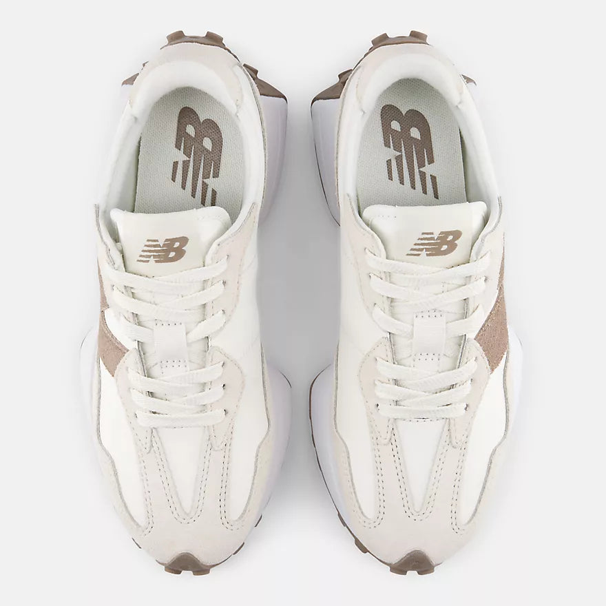 Pair of white sneakers with brown accents on a white background