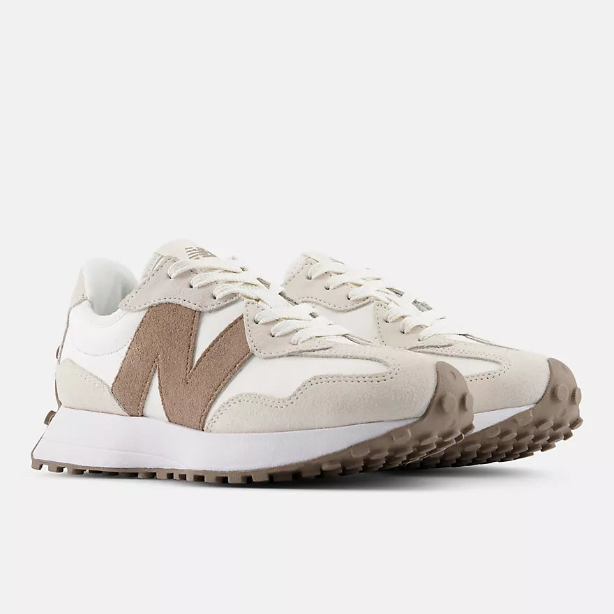 Pair of beige and brown sneakers on a white background