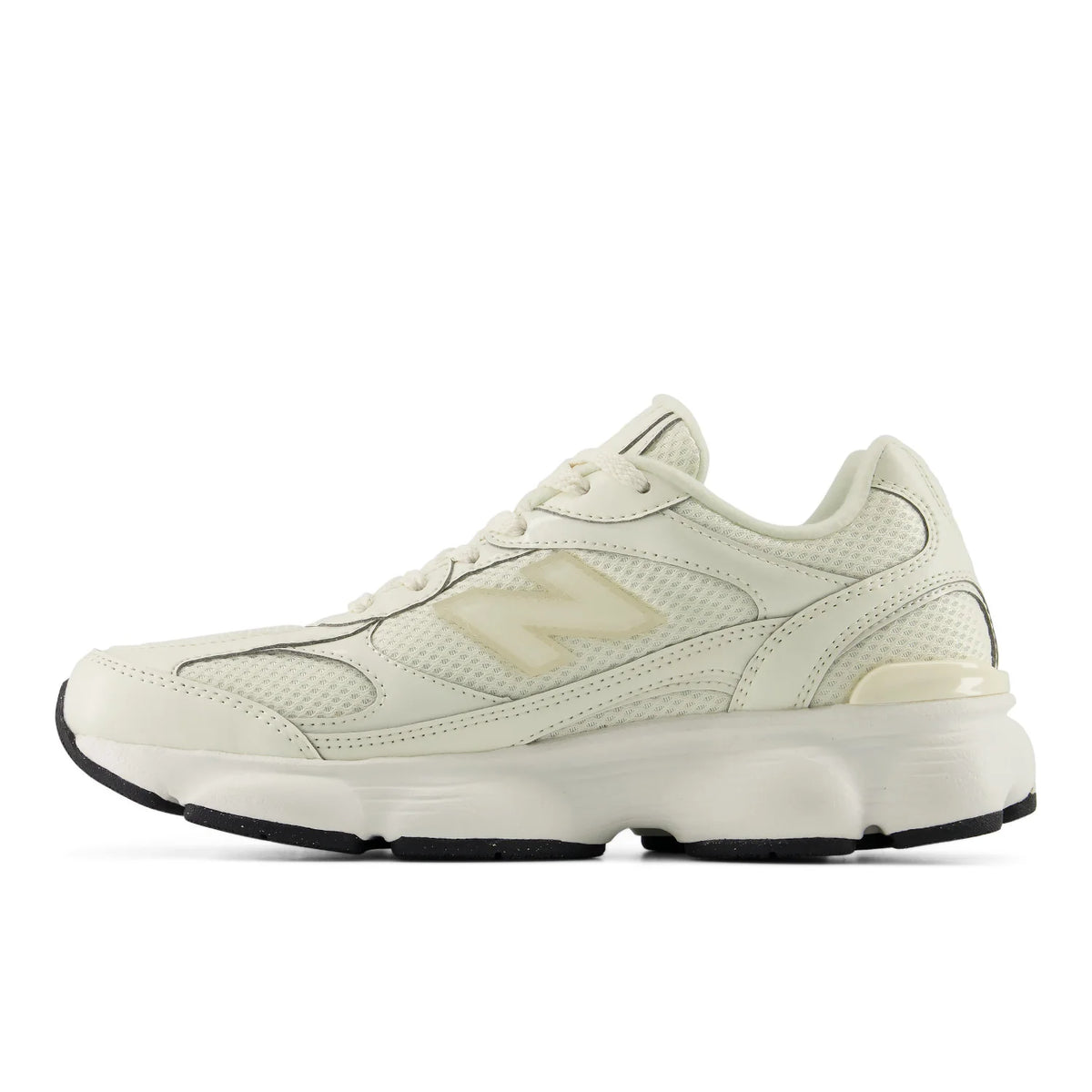 A New Balance sneaker in off-white and cream with a chunky sole, shown in a side profile on a white background.